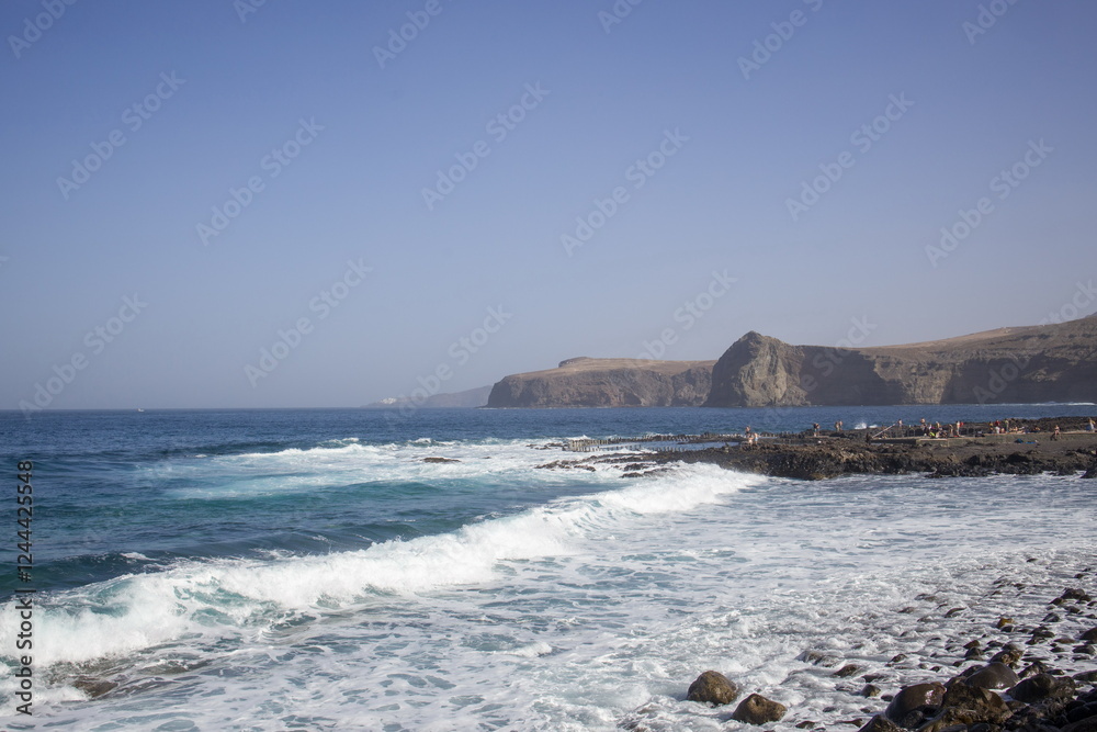 Waves crashing against a rocky shoreline in Gran Canaria.