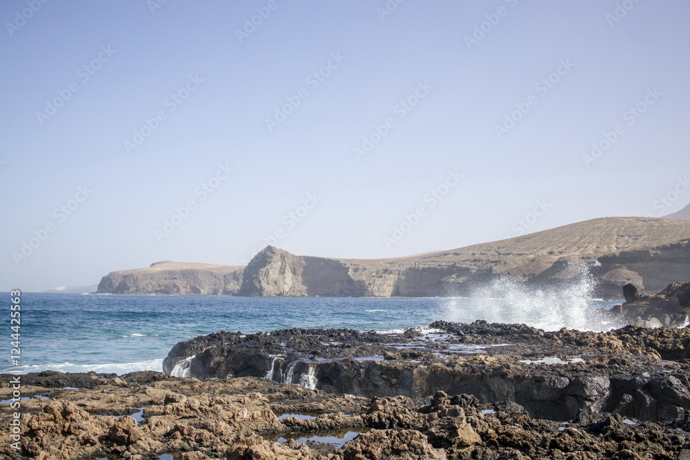 Waves crashing against a rocky shoreline in Gran Canaria.