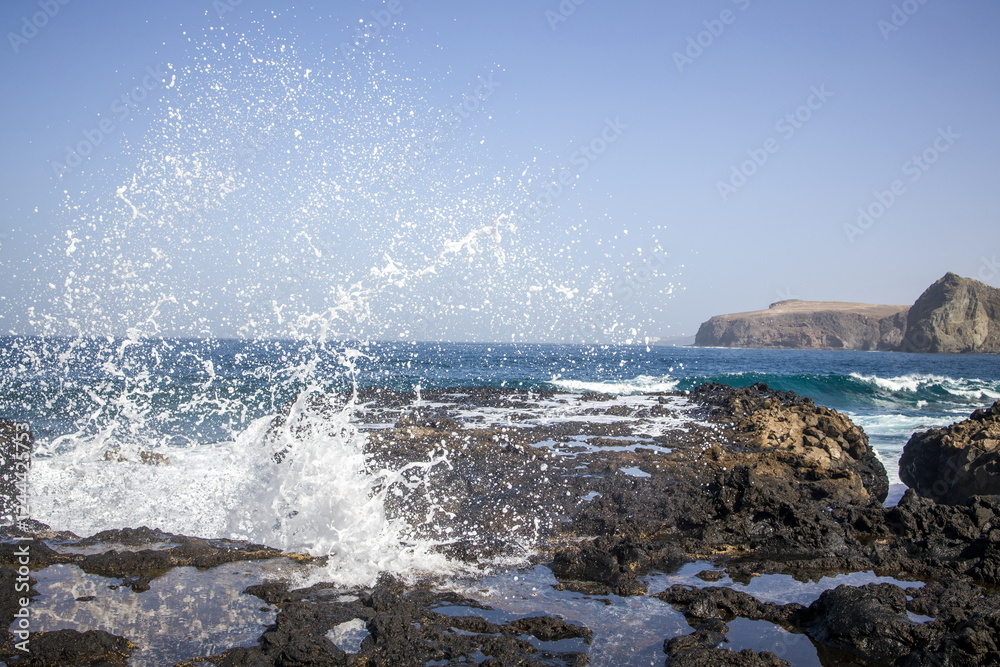 Waves crashing against a rocky shoreline in Gran Canaria.