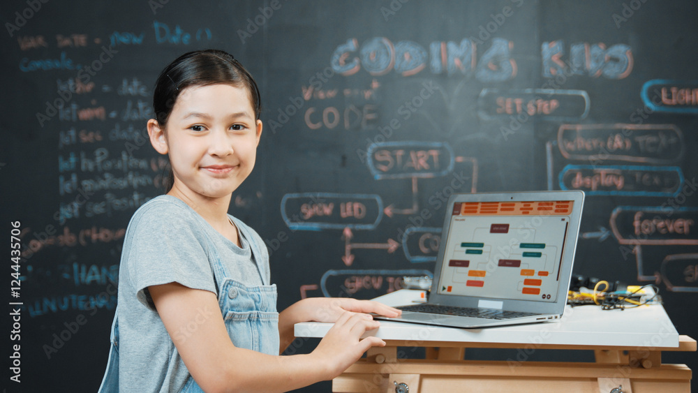 Asian student programing engineering code or prompt with equipment on table while turn around to looking at camera. Cute girl working by using laptop at board. Creative education concept. Edification. Asian student programing engineering code or prompt with equipment on table while turn around to looking at camera. Cute girl working by using laptop at board. Creative education concept. Edification.