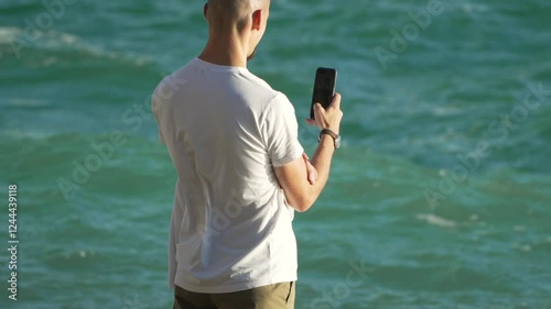 Man Beach Phone - Taking photo of the ocean on beach.