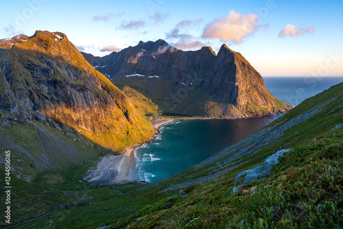 Midnight sun on Kvalvika beach, captured from Ryten mountain in Norway photo