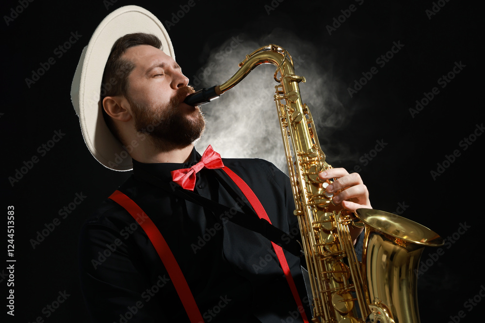 Naklejka premium Professional musician playing saxophone on black background with smoke