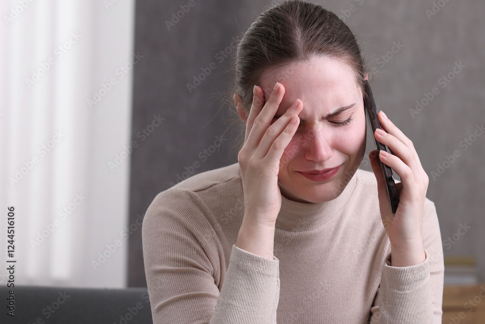 Stressed woman calling hotline for mental health help at home Stressed woman calling hotline for mental health help at home