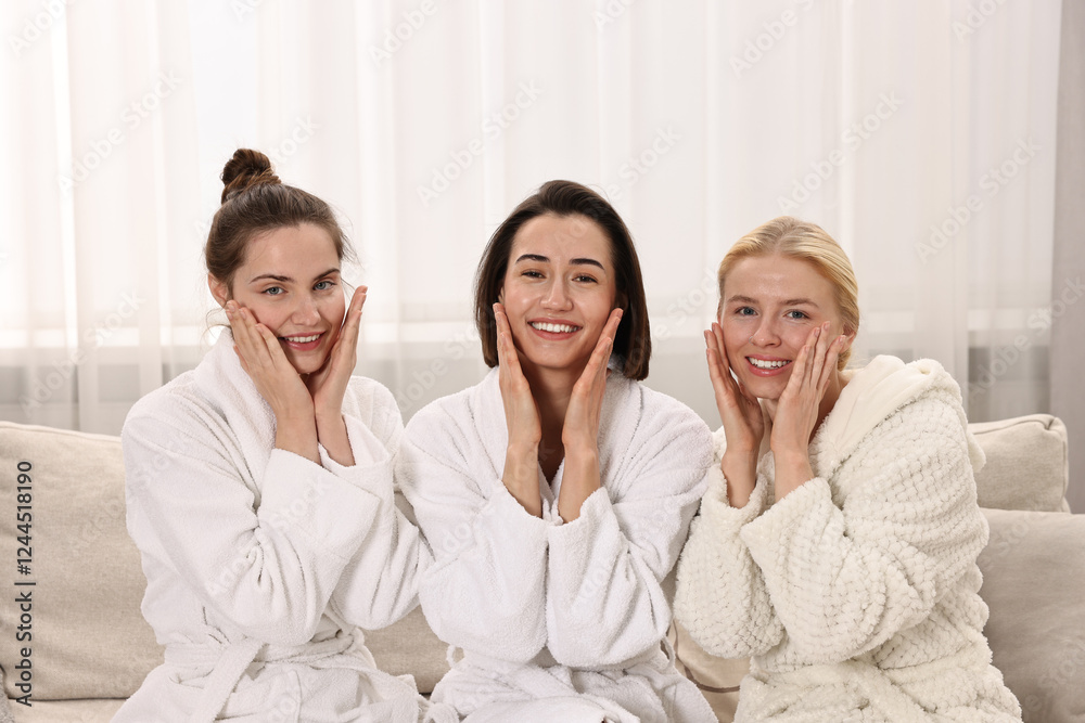 Happy woman wearing bathrobes on sofa in spa Happy woman wearing bathrobes on sofa in spa