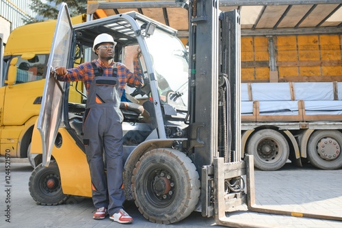 Wallpaper Mural Portrait of a happy African American male worker driving forklift at workplace Torontodigital.ca