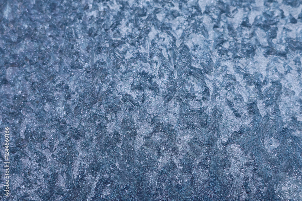 Frozen pattern of hoarfrost and frostwork structure on the glass. Color texture photo for background. Frozen pattern of hoarfrost and frostwork structure on the glass. Color texture photo for background.
