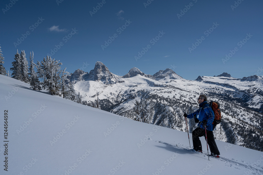 USA, Wyoming. Skier breaking trail in powder snow, Teton Mountains. (MR) USA, Wyoming. Skier breaking trail in powder snow, Teton Mountains. (MR)