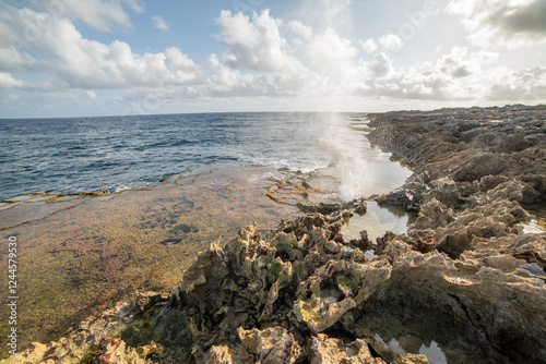 Ocean blowhole with blue sky background 