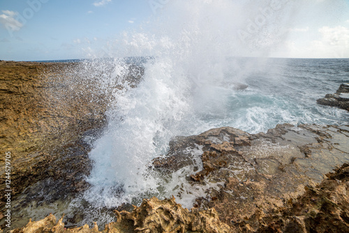 ocean blowhole with bright blue sky 