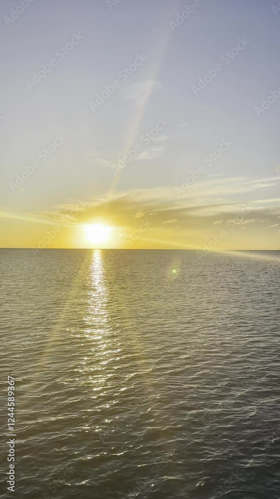 Stunning sunset over the ocean in Bahamas with golden light reflecting on the rippling water creating a peaceful and serene atmosphere concept of travel tourism nature coastal scenery. Copyspace Stunning sunset over the ocean in Bahamas with golden light reflecting on the rippling water creating a peaceful and serene atmosphere concept of travel tourism nature coastal scenery. Copyspace