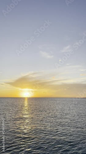 Wallpaper Mural A serene sunset over the ocean casting golden hues across the sky and water with peaceful waves reflecting the warm evening glow and space for text concept of travel tourism nature Torontodigital.ca