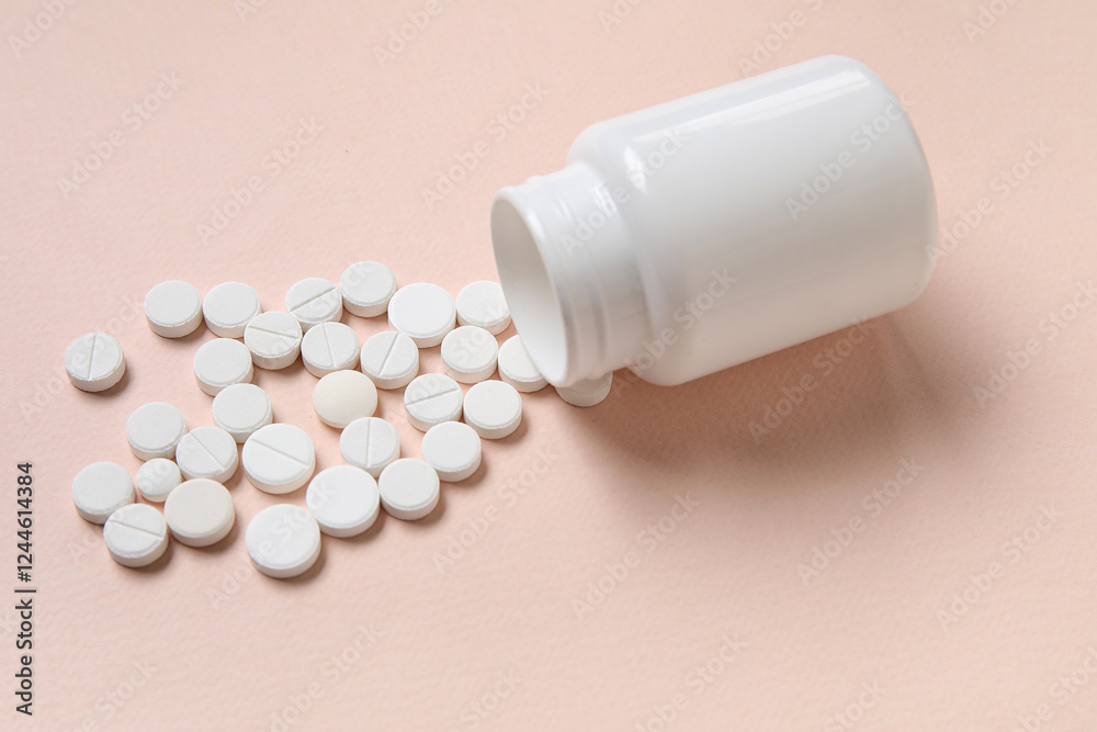 Jar with scattered pills on beige background Jar with scattered pills on beige background