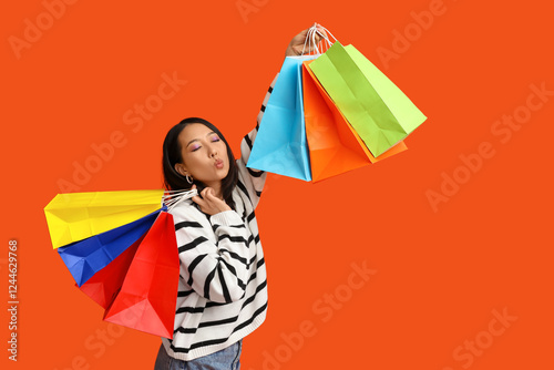 Happy asian woman with shop...