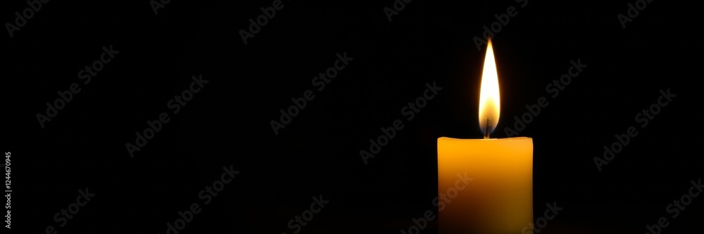 Candle flame glowing softly in darkness Candle flame glowing softly in darkness