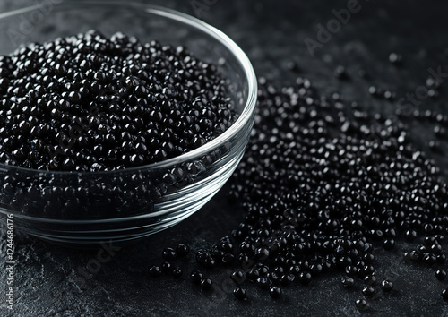 Caspian Sea caviar presented in a luxurious dish, garnished with fine black pearls, overhead view, professionally styled food photography. photo