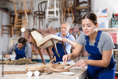 Portrait of skillful repair woman carpenter renovating chair furniture using tools in woodwork studio