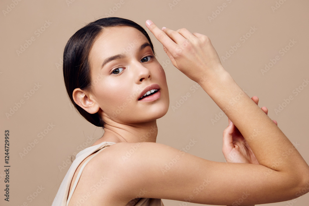 Portrait of a young woman with natural makeup against a beige background, showcasing healthy skin and confident expression, perfect for beauty and skincare concepts Portrait of a young woman with natural makeup against a beige background, showcasing healthy skin and confident expression, perfect for beauty and skincare concepts