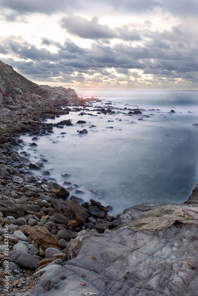 Obraz premium the Cala Viola gulf in the Porto Conte Regional Park, Alghero, Sassari, Sardinia, Italy. Long exposure and Motion blur on sea waves.