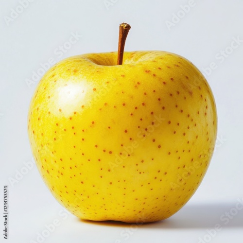 Golden Delicious Apple: A vibrant, ripe golden delicious apple, showcasing its smooth, yellow skin dotted with tiny brown lenticels, sits center frame against a subtle backdrop.   photo