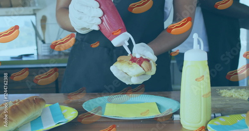 Squeezing ketchup on hot dog, person preparing food with hot dog image overlay