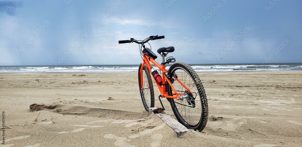 Fototapeta premium orange bicycle on a deserted beach