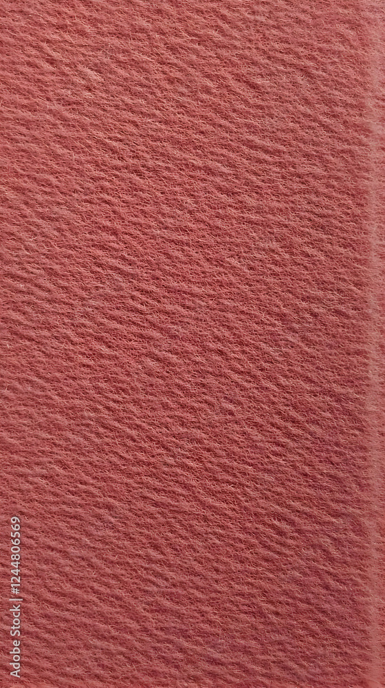 Fototapeta premium Close-up View of a Textured Dusty Rose Fabric Creates a Soft and Elegant Background.