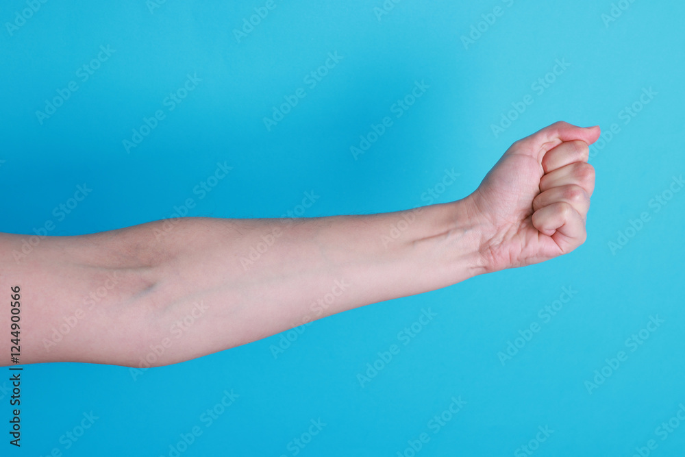 Woman with visible hand veins on light blue background, closeup Woman with visible hand veins on light blue background, closeup
