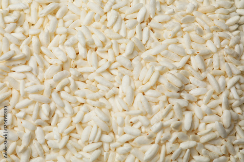 Wholegrain puffed rice as background, closeup view photo