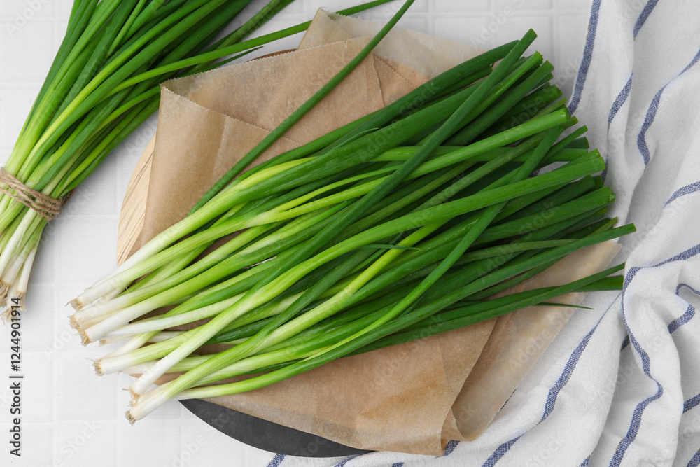 Fresh green onions on white tiled table, top view Fresh green onions on white tiled table, top view
