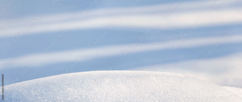 Winter christmas background, banner - view of the snowdrift sparkling in the rays of the winter sun, selective focus