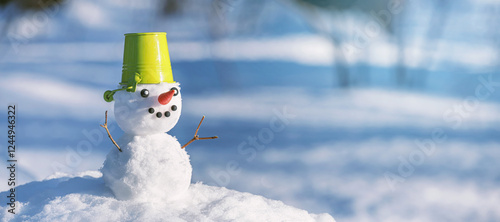 Christmas winter banner with snowman on snow background in winter forest. Holiday background with copy space for text