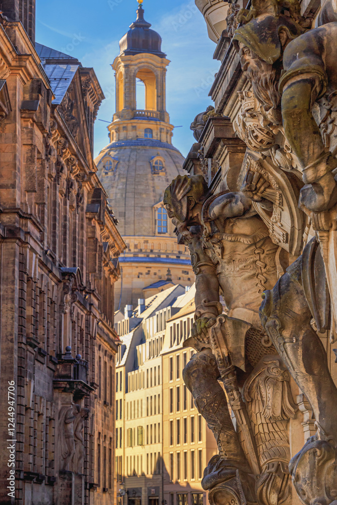 Cityscape - street view with sculptures of gatekeepers on the George Gate of Dresden Castle against the backdrop of the Dresden Frauenkirche, Dresden, Germany