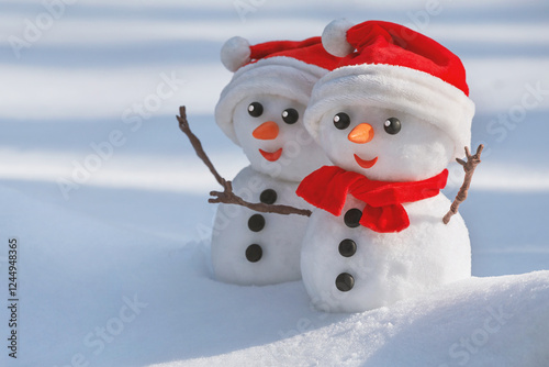 Obraz na płótnie View of a couple of snowmen in a santa hats on their heads in a winter forest. Holiday christmas background with copy space for text w salonie