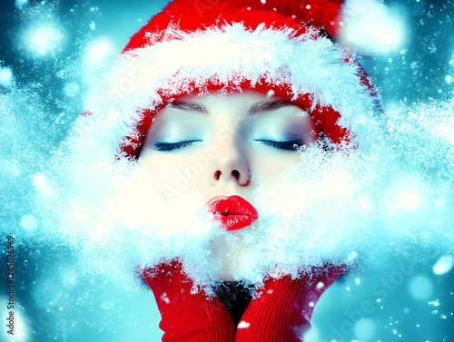 Beautiful Woman Blowing Sno...