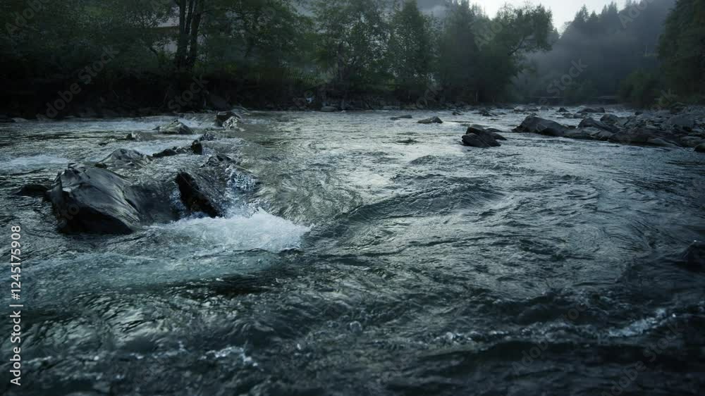 4k aerial video capturing rapid stream flow over rocks with clear water splashing and rippling in a mountain landscape