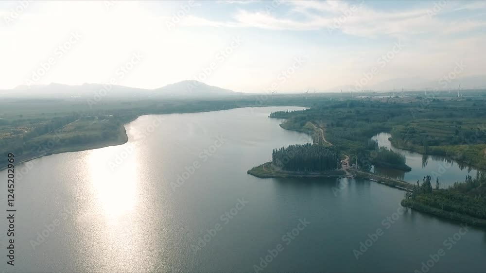 4k aerial video showcasing serene lakes and rivers near far mountains with wind power infrastructure 4k aerial video showcasing serene lakes and rivers near far mountains with wind power infrastructure