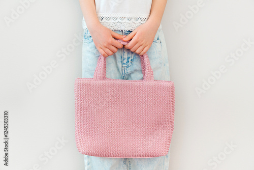 Pink empty beach bag in hand. Template for design, mockup. White background