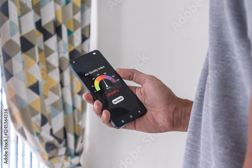 Man checking air quality index using an app on his smartphone