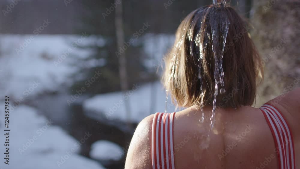 Rinsing sweat and toxins off after sauna with scoop of icy cold water on head