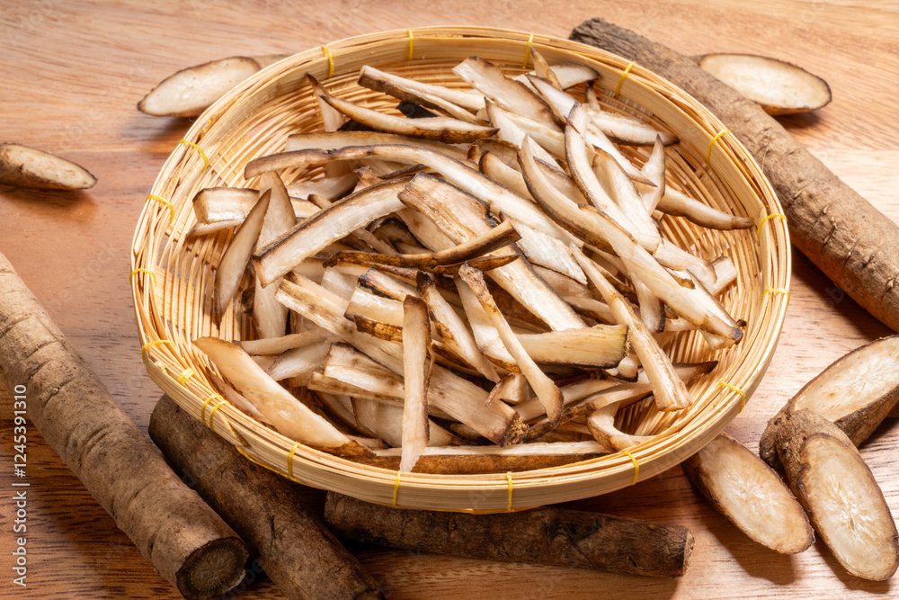 Sliced Gobo herb in wooden basket on wooden plate, Burdock Root or Gobo herb medicinal plants on wooden backgroun Sliced Gobo herb in wooden basket on wooden plate, Burdock Root or Gobo herb medicinal plants on wooden backgroun