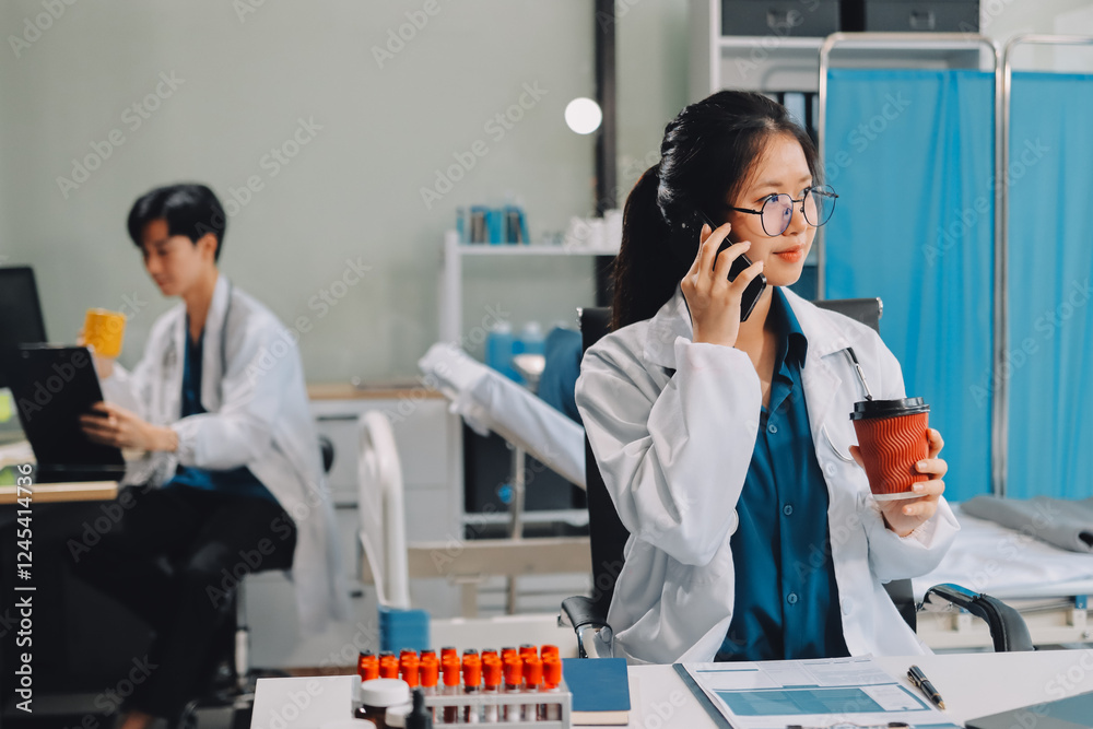 Naklejka premium Positive doctor working on laptop in medical office, portrait.
