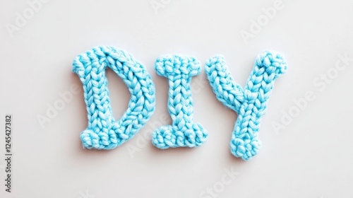 Blue knitted diy letters on white background photo