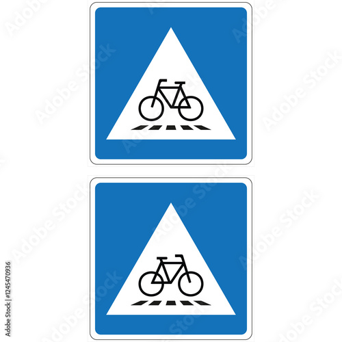 Two vertical blue traffic signs indicating a designated bicycle crossing area with a white triangle and black bicycle symbol