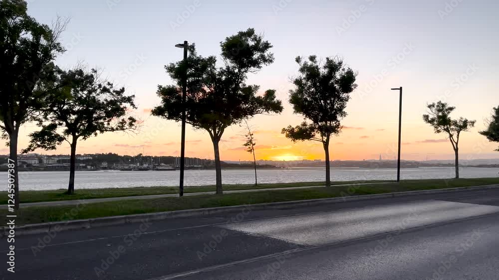 A stunning sunset view along the waterfront, with trees silhouetted against the vibrant sky. The warm colors of the sun fading behind the horizon create a tranquil and picturesque scene. A stunning sunset view along the waterfront, with trees silhouetted against the vibrant sky. The warm colors of the sun fading behind the horizon create a tranquil and picturesque scene.