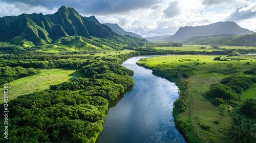 A river flowing gently through a lush green valley surrounded by mountains.