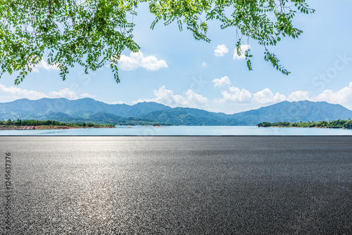 Obraz na płótnie Asphalt road and blue lake with mountain nature landscape under blue sky w salonie
