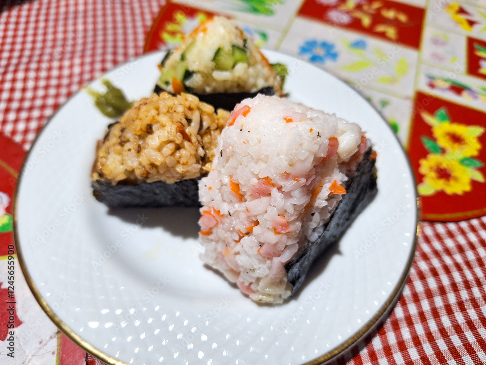 Tuna, Crab, and Vegetable onigiri on a white plate Tuna, Crab, and Vegetable onigiri on a white plate