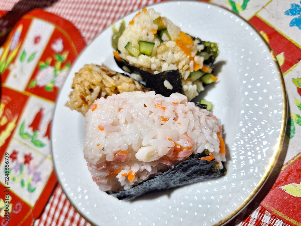 Tuna, Crab, and Vegetable onigiri on a white plate Tuna, Crab, and Vegetable onigiri on a white plate