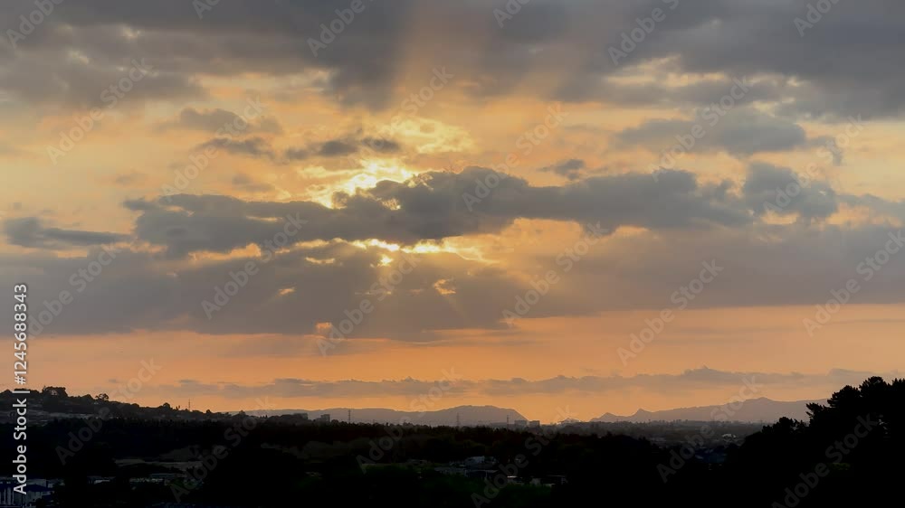 The sun is setting slowly on the horizon of hills and high-end residential areas in Auckland, New Zealand. The sun is setting slowly on the horizon of hills and high-end residential areas in Auckland, New Zealand.